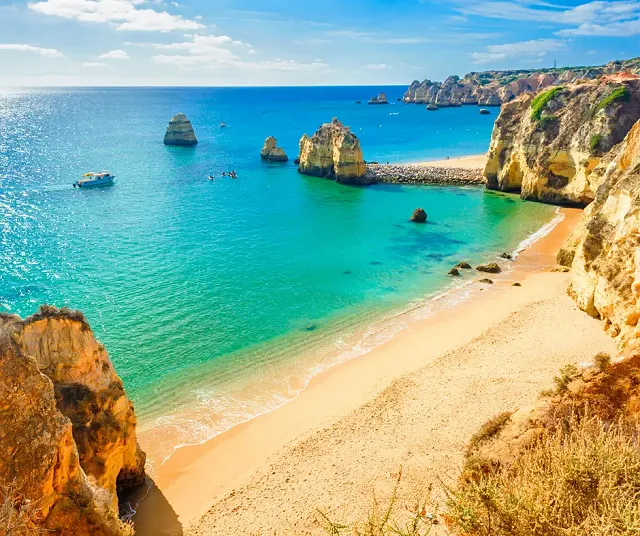Looking off a cliff in the algarve down at the beach and sea